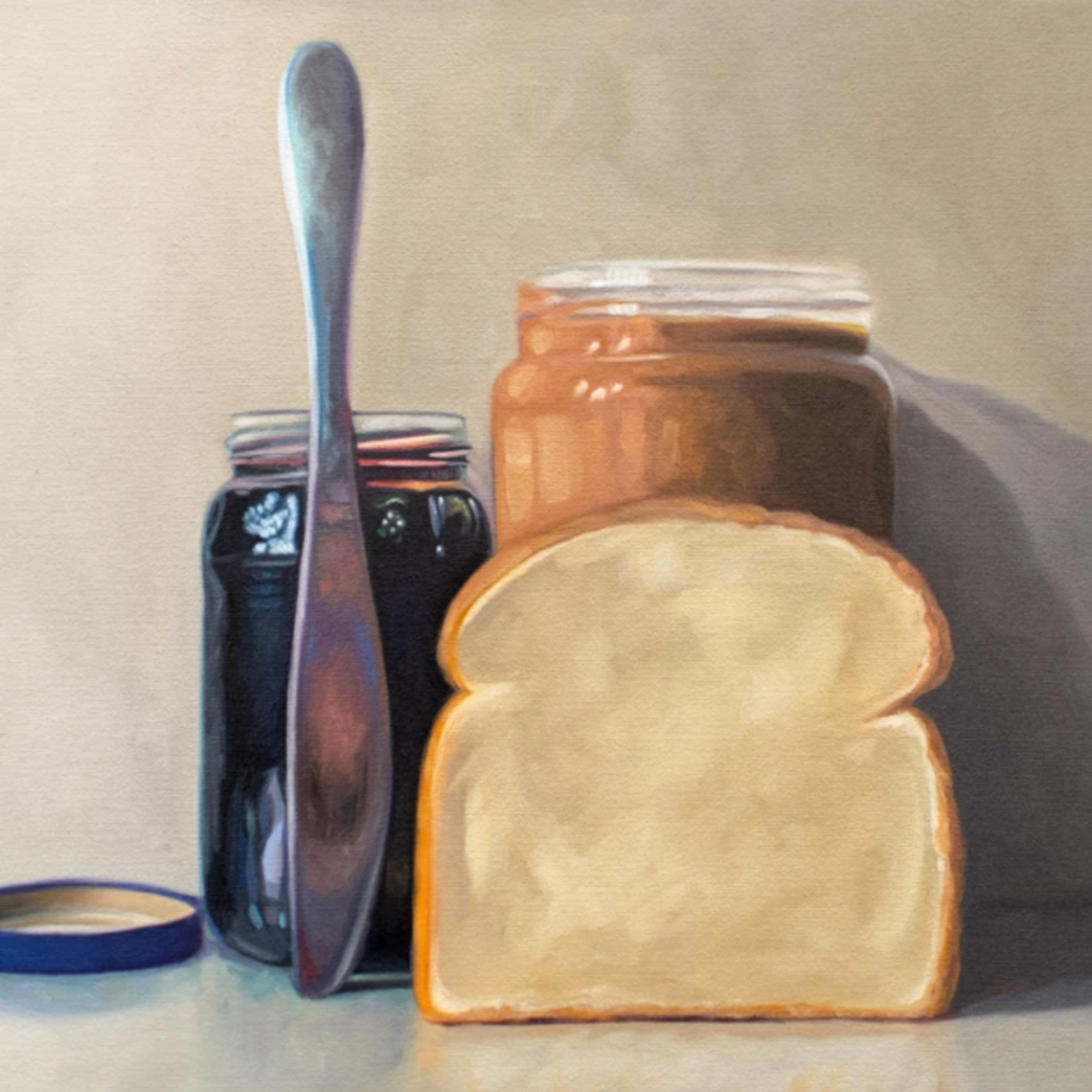 All the things required to make a peanut butter and jelly sandwich lined up and ready to go on a light and neutral backdrop with subtle reflections.